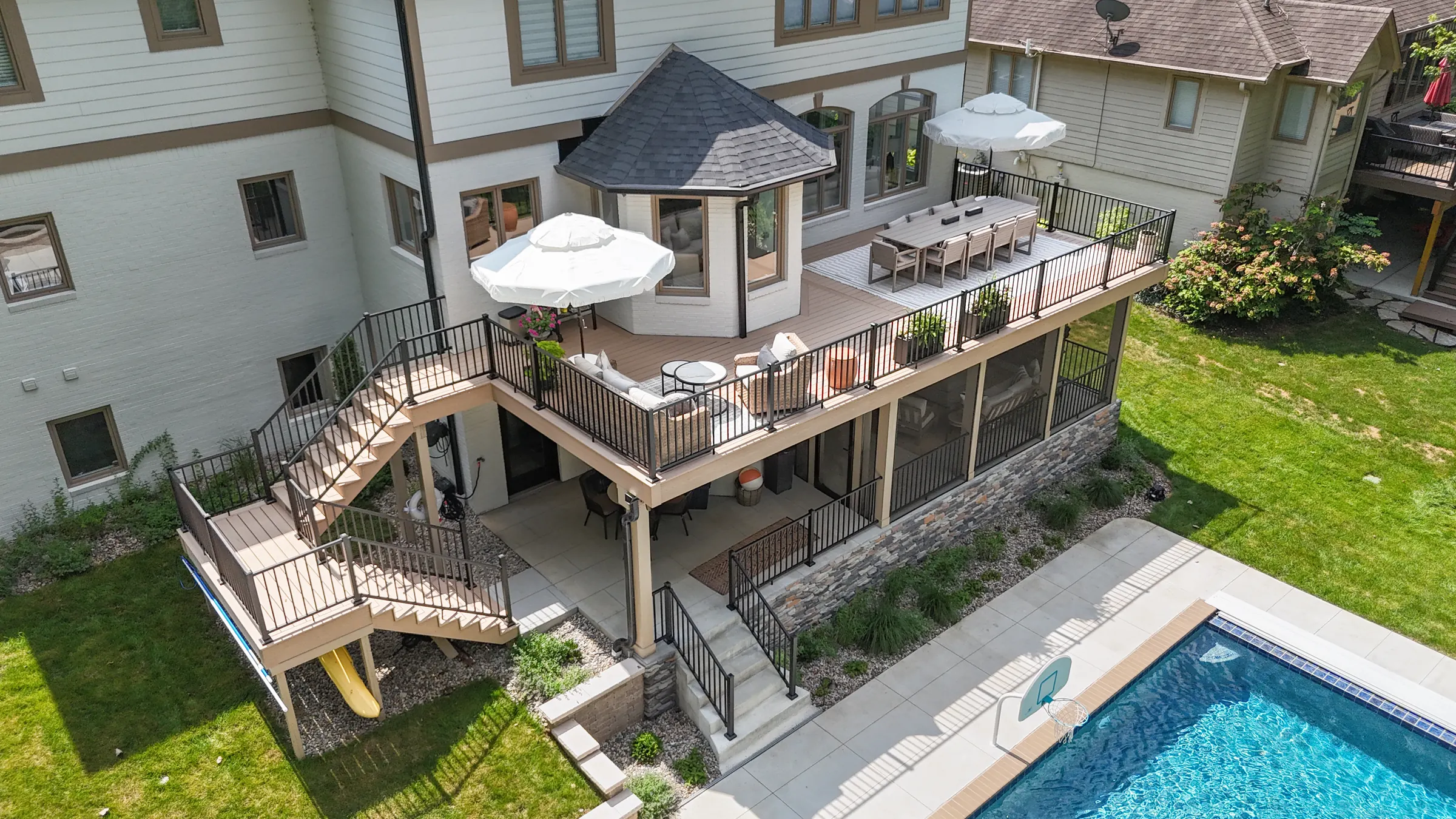 Aerial view composite deck under deck drainage screened porch pool in Indianapolis.